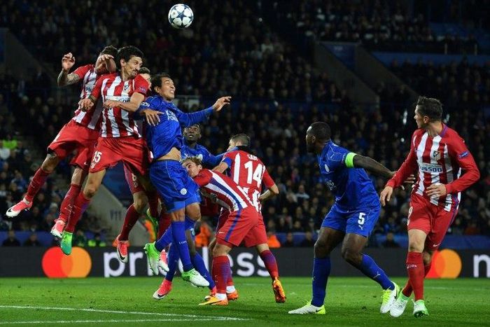 Leicester City's striker Leonardo Ulloa (3R) vies with Atletico Madrid's defender Stefan Savic (2R) during the UEFA Champions League quarter-final second leg football match April 18, 2017