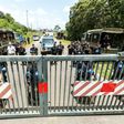 Riot policemen stand at the entrance of the Kourou space center (Centre Spatial Guyanais) during a protest over security and the state of the economy on April 4, 2017 in Kourou, French Guiana
