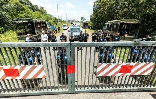 Riot policemen stand at the entrance of the Kourou space center (Centre Spatial Guyanais) during a protest over security and the state of the economy on April 4, 2017 in Kourou, French Guiana