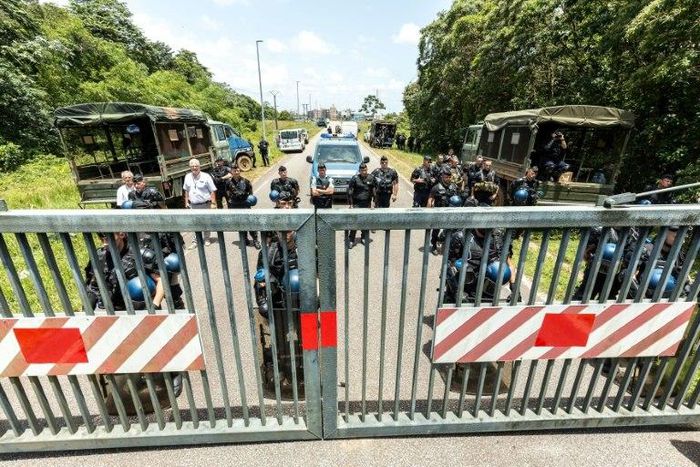 Riot policemen stand at the entrance of the Kourou space center (Centre Spatial Guyanais) during a protest over security and the state of the economy on April 4, 2017 in Kourou, French Guiana