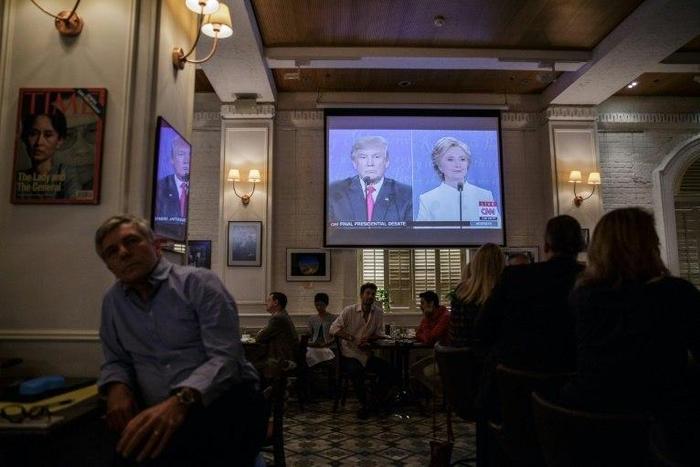 People watch a live screening of the third and final presidential debate between Republican nominee Donald Trump and Democratic nominee Hillary Clinton