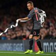 Bayern Munich's Brazilian defender Rafinha clears the pitch of toilet roll before the Champions League last 16 second-leg against Arsenal at The Emirates Stadium in London on March 7, 2017