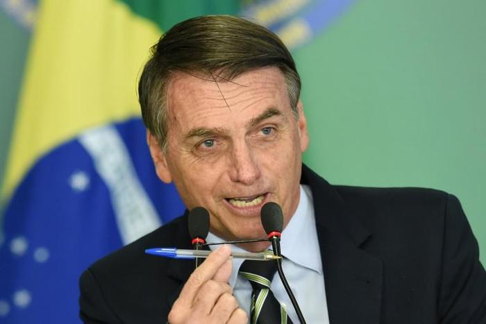 Brazilian President Jair Bolsonaro before signing a decree that makes it easier for adults with no criminal records to buy guns and keep them at home
