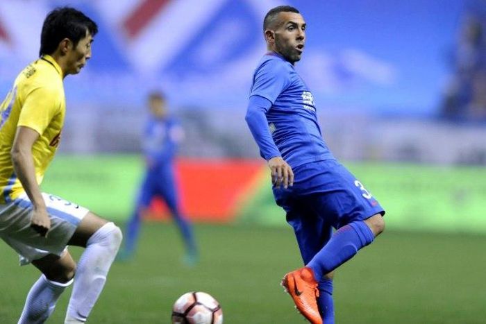 Shanghai Shenhua's Argentine striker Carlos Tevez (R) is in hot water after being spotted at Disneyland after missing a game with his Chinese club