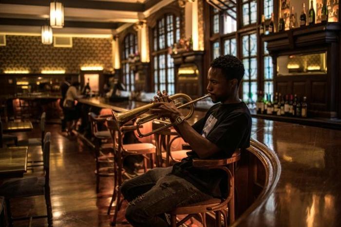 A musician plays at the bar of the Rand Club, the imposing Edwardian-style club in Johannesburg's vibrant centre