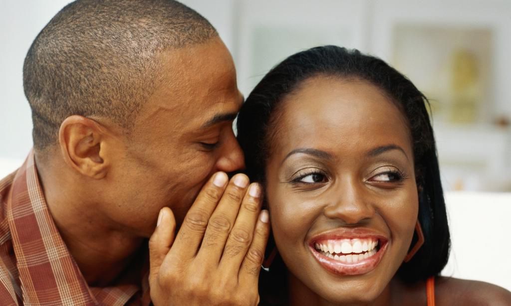 Man whispering to woman's ear(citinewsroom)