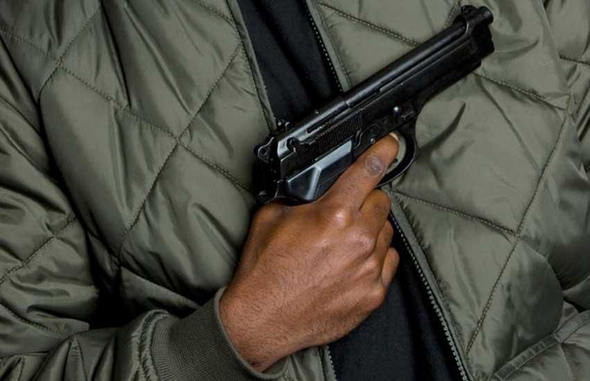 Anonymous person hold gun