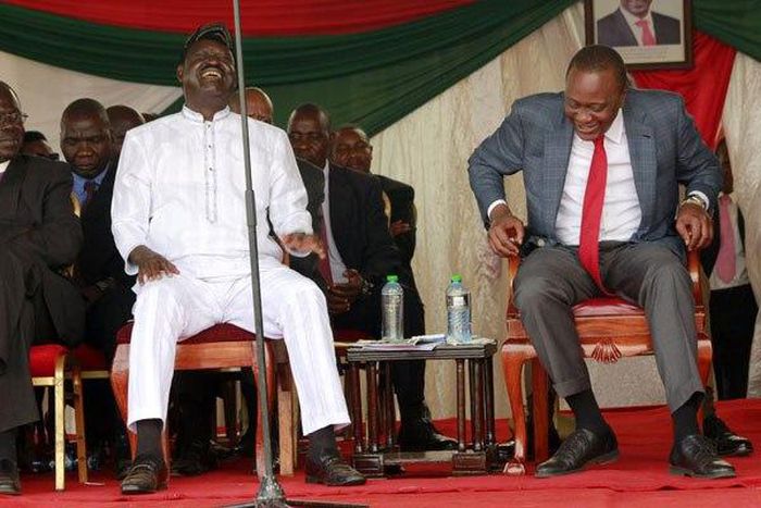 President Uhuru Kenyatta and Raila Odinga share a light moment at Uzima University in Kisumu on June 29, 2015.