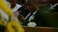 Janet Kanini's husband during her requiem service