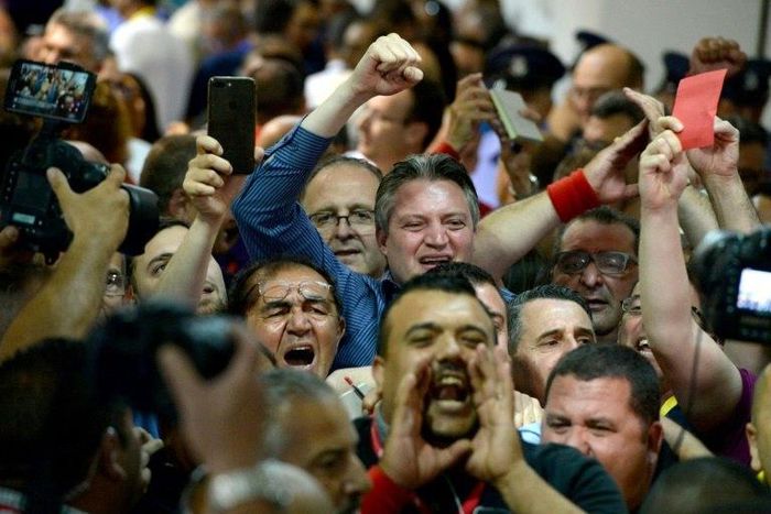 Malta's Minister within the Office of the Prime Minister, Konrad Mizzi (C) celebrates with Labour Party's supporters the results of Malta's general election on June 4, 2017 at a polling station in Naxxar