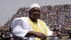 Gambian President Adama Barrow looks at the audience from the roof of a car as he arrives at the Independence Stadium in Bakau, west of the capital Banjul for his inauguration ceremony, on February 18, 2017