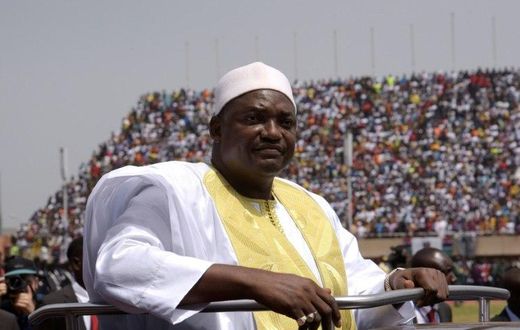 Gambian President Adama Barrow looks at the audience from the roof of a car as he arrives at the Independence Stadium in Bakau, west of the capital Banjul for his inauguration ceremony, on February 18, 2017