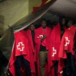 Migrant people in a Red Cross tent on their arrival on a Spanish coast guard vessel at the southern Spanish port of Malaga on February 26, 2017