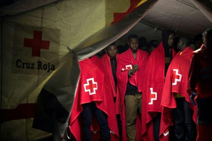 Migrant people in a Red Cross tent on their arrival on a Spanish coast guard vessel at the southern Spanish port of Malaga on February 26, 2017