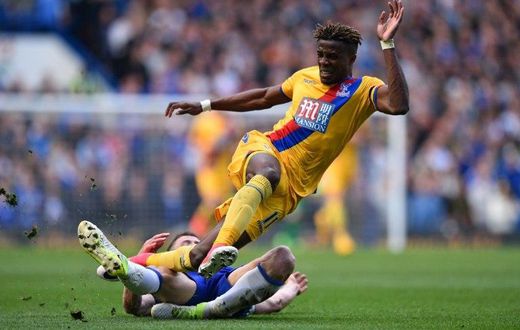 Crystal Palace's Wilfried Zaha (up) vies with Chelsea's English defender Gary Cahill during their English Premier League football match in London on April 1, 2017