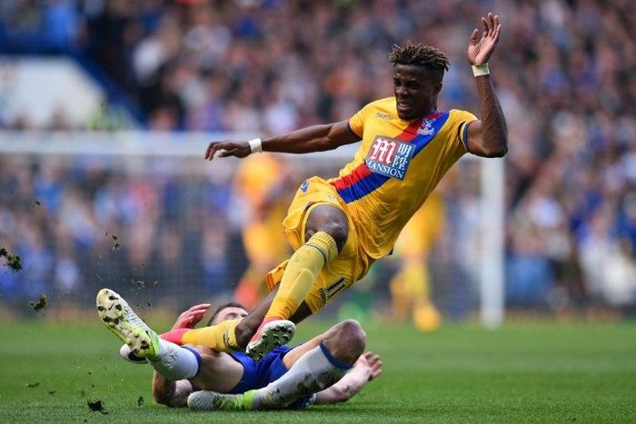 Crystal Palace's Wilfried Zaha (up) vies with Chelsea's English defender Gary Cahill during their English Premier League football match in London on April 1, 2017