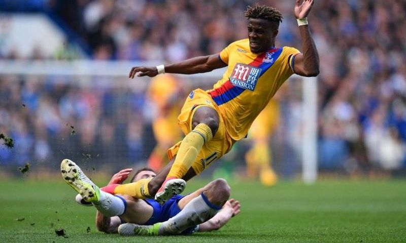 Crystal Palace's Wilfried Zaha (up) vies with Chelsea's English defender Gary Cahill during their English Premier League football match in London on April 1, 2017