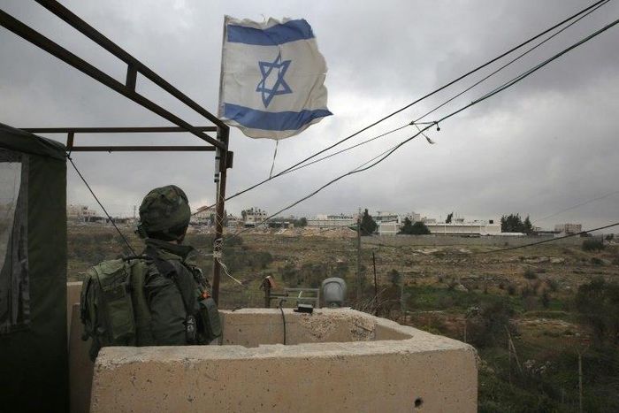 An Israeli soldier stands guard in a monitoring cabin near the West Bank city of Ramallah