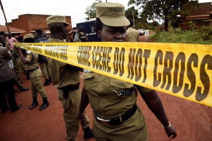 Uganda's police officers cordon off the scene where senior police officer Andrew Felix Kaweesi was murdered in a Kampala Suburb on March 17, 2017