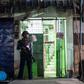 A policeman secures the entrance to the immigration office in South Dagon, a suburb of Yangon, following multiple explosions on November 24, 2016