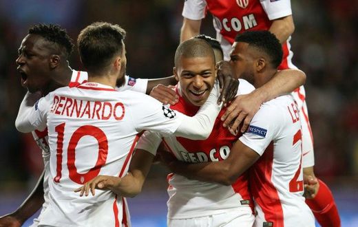 Monaco's Kylian Mbappe (C) and teammates celebrate his opening goal during their UEFA Champions League 2nd leg quarter-final football match against Borussia Dortmund on April 19, 2017 at the Louis II stadium in Monaco