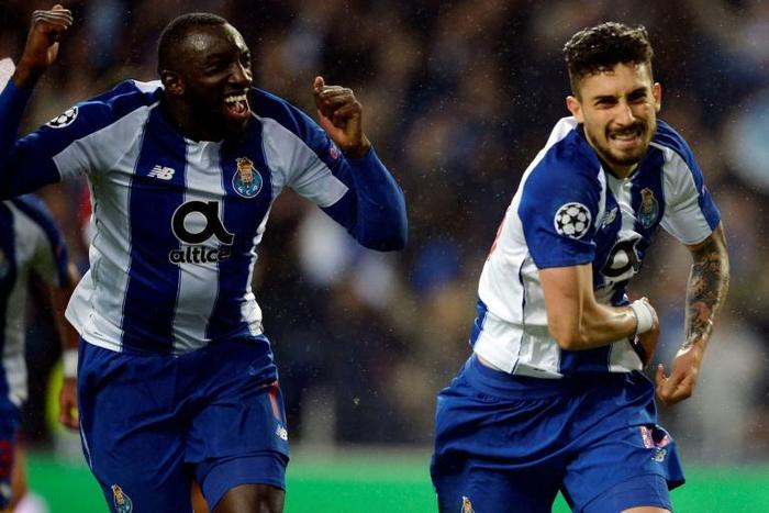 Porto's Brazilian defender Alex Telles (R) celebrates a goal with teammate Malian forward Moussa Marega during the UEFA Champions League round of 16 second leg football match between FC Porto and AS Roma at the Dragao stadium in Porto on March 6, 2019.