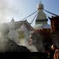 A Buddhist devotee lights incense at Kathmandu's Boudhanath stupa on November 22, 2016