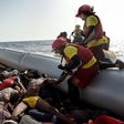 Members of Spanish humanitarian NGO Proactiva Open Arms, drag corpses of refugees and migrants after a rescue operation off the coast of Libya on October 4, 2016