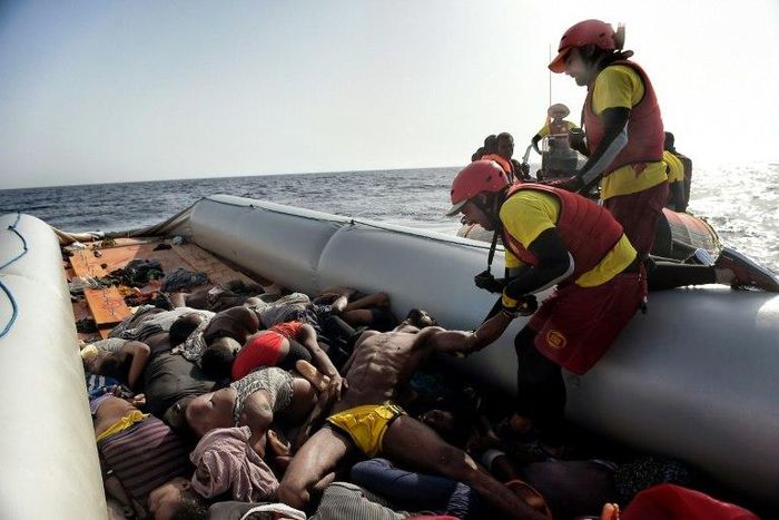 Members of Spanish humanitarian NGO Proactiva Open Arms, drag corpses of refugees and migrants after a rescue operation off the coast of Libya on October 4, 2016