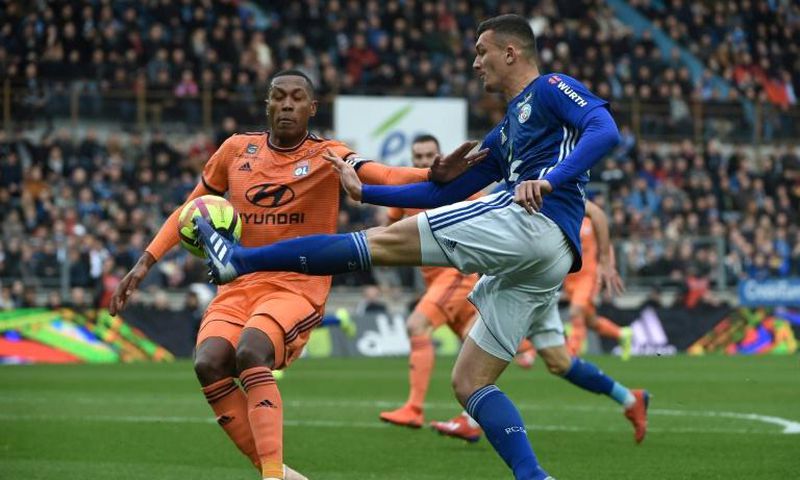 Painful end: Lyon's Brazilian defender Marcelo faces up to Strasbourg forward Ludovic Ajorque on Saturday