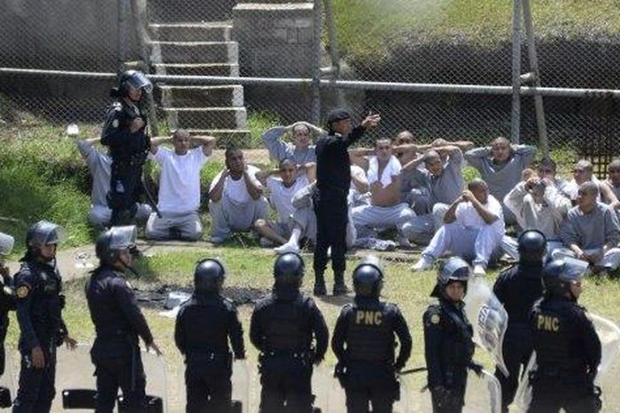 Riot police control inmates at a juvenile detention center in San Jose Pinula, east of Guatemala City, following a deadly prison riot