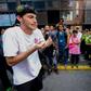 A student faces a line of police blocking a march in Caracas protesting the government of President Nicolas Maduro
