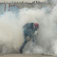 A demonstrator is swamped by tear gas during clashes with riot police during a protest against Venezuelan President Nicolas Maduro, in Caracas