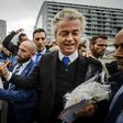 Dutch right-wing politician Geert Wilders (2nd R) of the Freedom Party (PVV) shakes hands with supporters during a protest against emergency accommodation for refugees in Rotterdam, in 2015