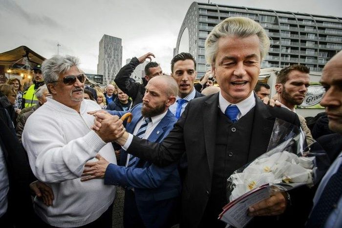 Dutch right-wing politician Geert Wilders (2nd R) of the Freedom Party (PVV) shakes hands with supporters during a protest against emergency accommodation for refugees in Rotterdam, in 2015