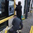 Workers installed wooden planks to protect the windows and ATM of a bank on Friday in Bourges, central France, where many "yellow vest" protesters plan to meet Saturday