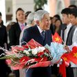 Emperor Akihito (centre) greets people after arriving at a hotel in Hanoi on February 28, 2017