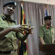 Ugandan police spokesman Andrew Kaweesi (Left) was shot and killed as he left his home in Kampala
