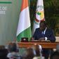 Ivory Coast's president Alassane Ouattara signs the country's revisited constitution on November 8, 2016 at the presidential palace in Abidjan