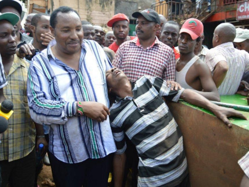 Governor Ferdinand waititu hold a drunk youth during a raid of bars in Wangige