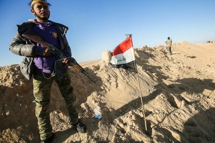 A fighter of the Hashed al-Shaabi (Popular Mobilisation) paramilitaries poses for a picture near the frontline village of Ayn al-Hisan, on the outskirts of west Mosul
