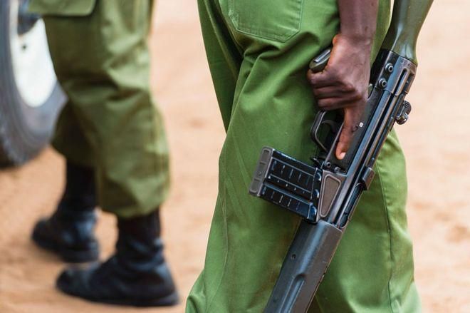 A Kenyan police officer holding a gun (Courtesy)