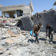 Iraqis clean up the rubble of destroyed buildings in the Mosul al-Jadida area following air strikes that reportedly killed civilians