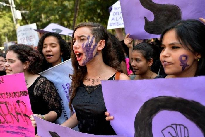 Women in Mexico City take part on October 19, 2016 in a march in solidarity for the brutal killing of a 16-year-old girl in Argentina where protesters held a one-hour "women's strike