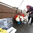 A woman lays flowers in Moscow at the site where Russian opposition leader Boris Nemtsov was shot dead to mark the second anniversary of his assassination in February 2017