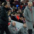 Arsenal's French manager Arsene Wenger (R) gestures to the fourth offficial, Andre Marriner during the English Premier League football match between Liverpool and Arsenal at Anfield in Liverpool, north west England on March 4, 2017