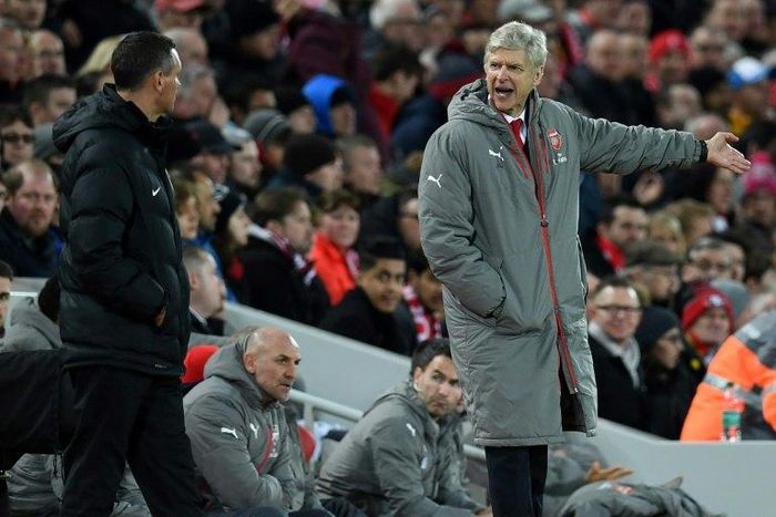 Arsenal's French manager Arsene Wenger (R) gestures to the fourth offficial, Andre Marriner during the English Premier League football match between Liverpool and Arsenal at Anfield in Liverpool, north west England on March 4, 2017