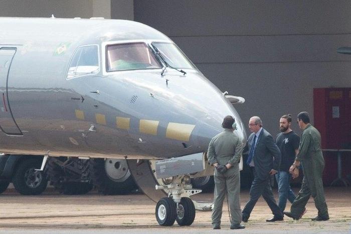 Eduardo Cunha was photographed being led to an airplane in the capital Brasilia under the eye of several guards, including a so-called 'hipster cop' which has caught the attention of Brazilian media