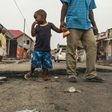 A child stares at the marks of burnt tyres following a protest in the Lingwala neighborhood in Kinshasa on December 20, 2016