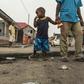 A child stares at the marks of burnt tyres following a protest in the Lingwala neighborhood in Kinshasa on December 20, 2016